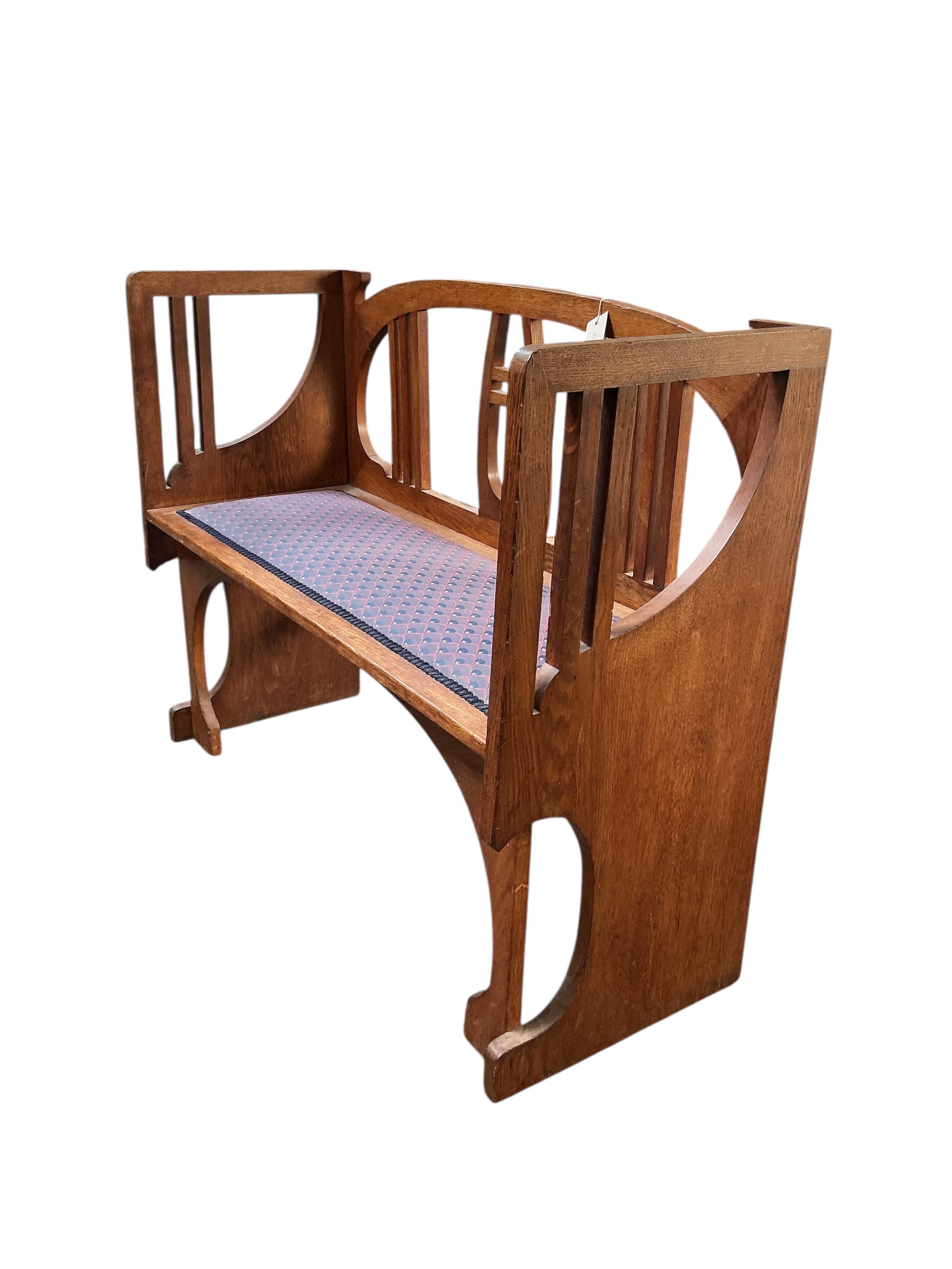 In the manner of Josef Hoffmann, an Art Nouveau oak chair-back settee and similar stool, settee width 110cm, depth 43cm, height 87cm.